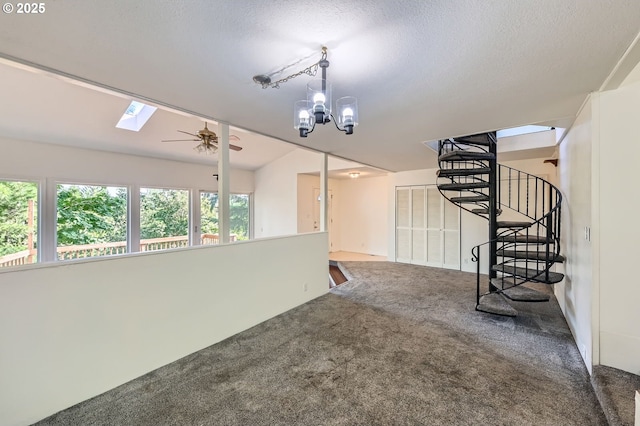 12140 SE Henderson Dr, Portland, OR 97266 - carpeted spare room with a ceiling fan, a textured ceiling, a skylight, stairway, and a chandelier