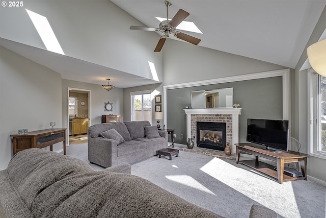 living room with lofted ceiling, light carpet, ceiling fan, and a brick fireplace