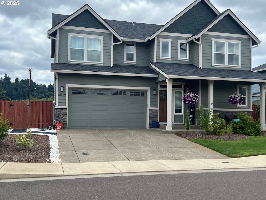 5013 Davis St SE, Turner, OR 97392 - craftsman-style house featuring stone siding, concrete driveway, a garage, and a porch