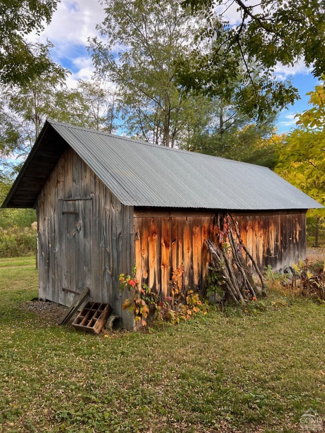 view of outbuilding with a lawn