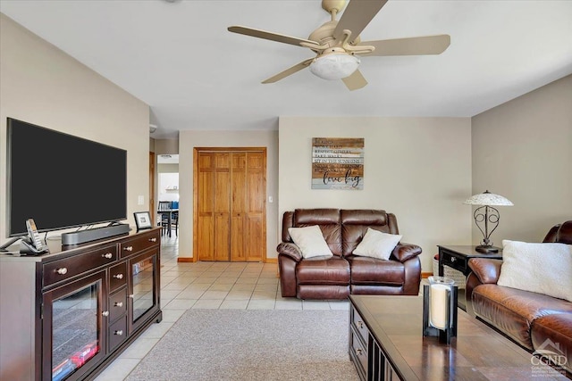 living room featuring light tile patterned floors and a ceiling fan