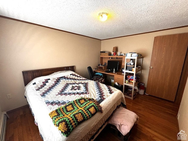 bedroom featuring baseboard heating, dark hardwood / wood-style flooring, and a textured ceiling