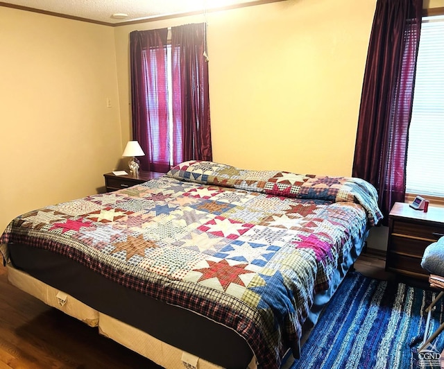 bedroom featuring wood-type flooring and a textured ceiling