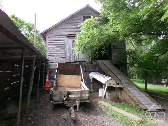 view of side of home with an outbuilding