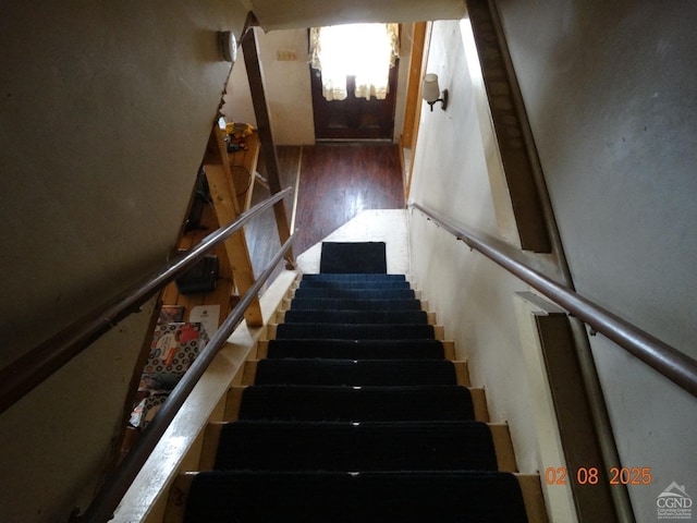 stairs featuring wood-type flooring