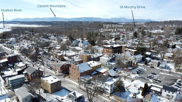 snowy aerial view featuring a mountain view