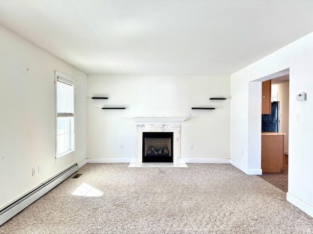 unfurnished living room with carpet floors, baseboards, a fireplace, and baseboard heating