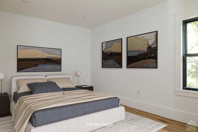 bedroom with wood-type flooring