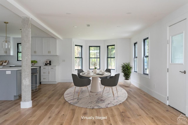 dining space with light hardwood / wood-style flooring