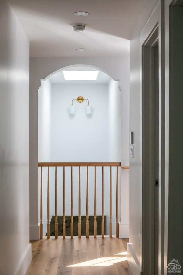 hallway with light hardwood / wood-style floors