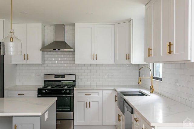 kitchen with white cabinets, wall chimney range hood, backsplash, and appliances with stainless steel finishes