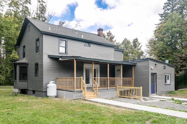 rear view of property with a lawn and a porch