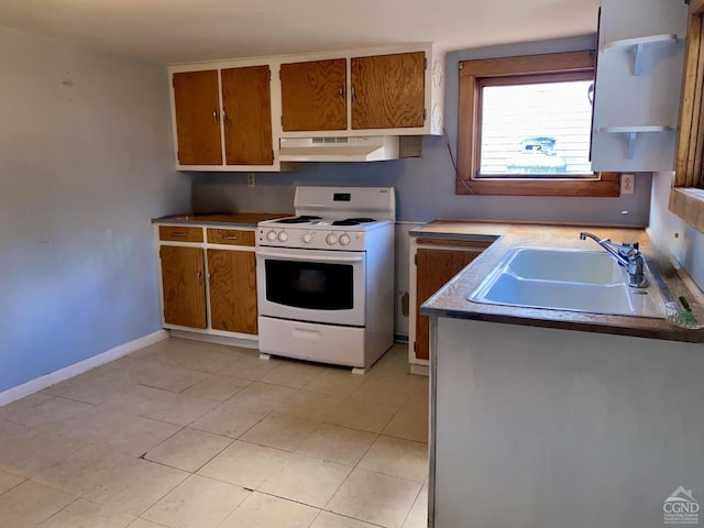 kitchen with white range oven, light tile patterned floors, and sink