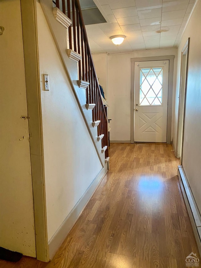 doorway featuring a baseboard radiator and light wood-type flooring