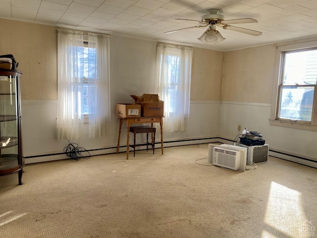 interior space featuring carpet flooring, ceiling fan, and baseboard heating