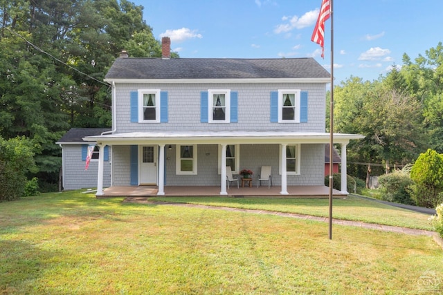 country-style home featuring covered porch and a front lawn