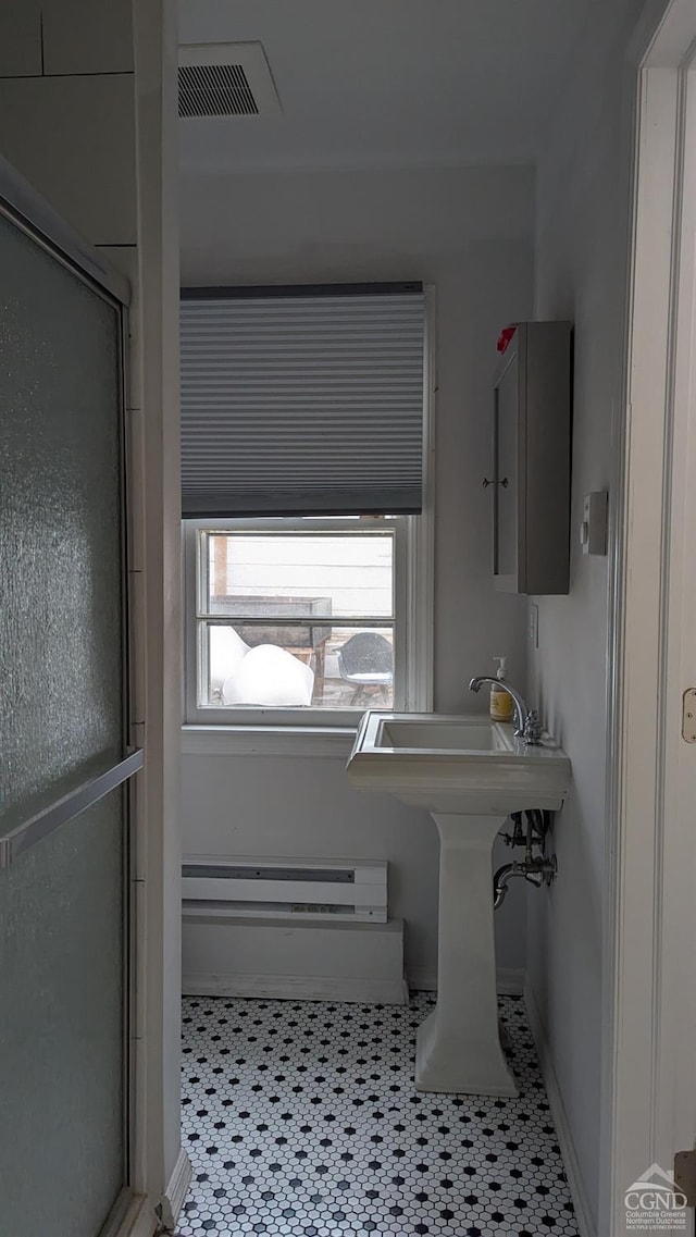 bathroom featuring walk in shower and a baseboard radiator