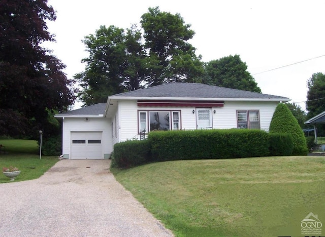 view of front of home featuring a front yard and a garage