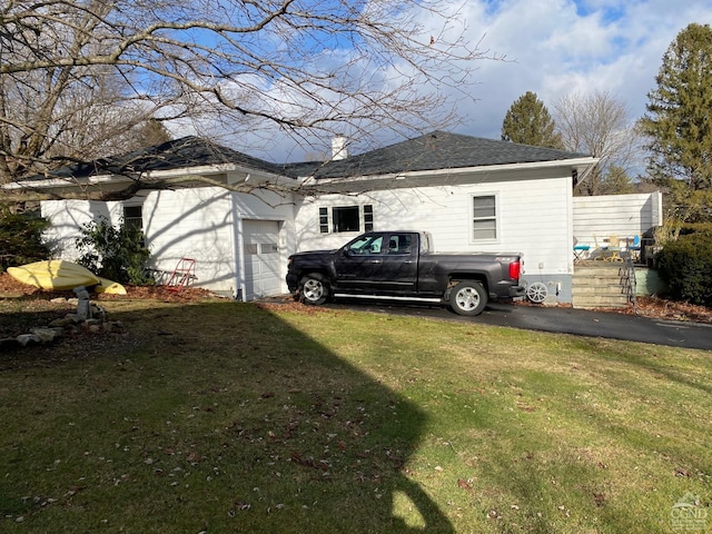 view of property exterior with a yard and a garage