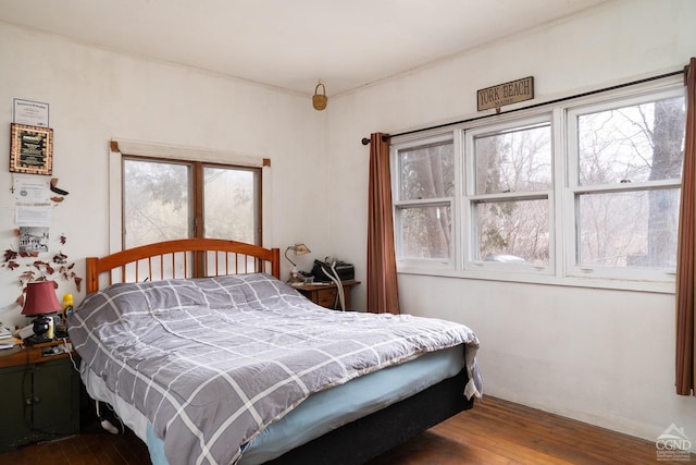 bedroom with dark wood finished floors