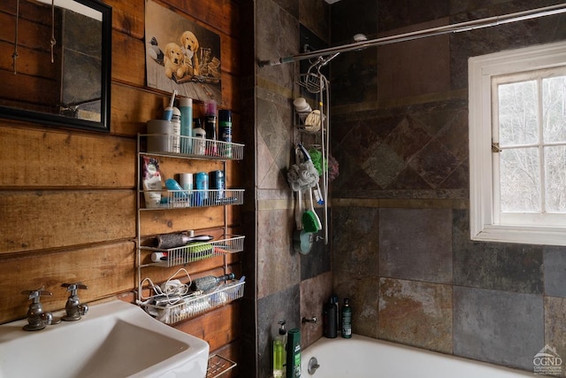 bathroom featuring a sink and bathing tub / shower combination