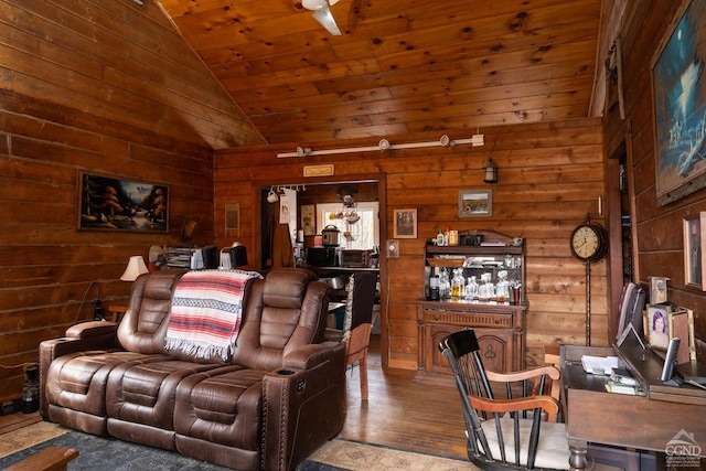 living room with lofted ceiling, wooden ceiling, wood finished floors, and wood walls