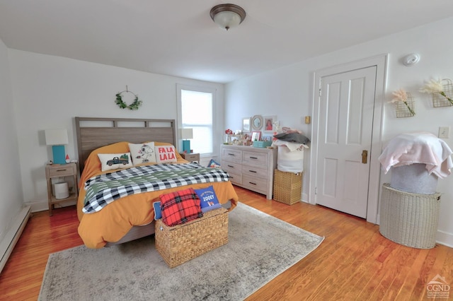 bedroom featuring light hardwood / wood-style floors and a baseboard radiator