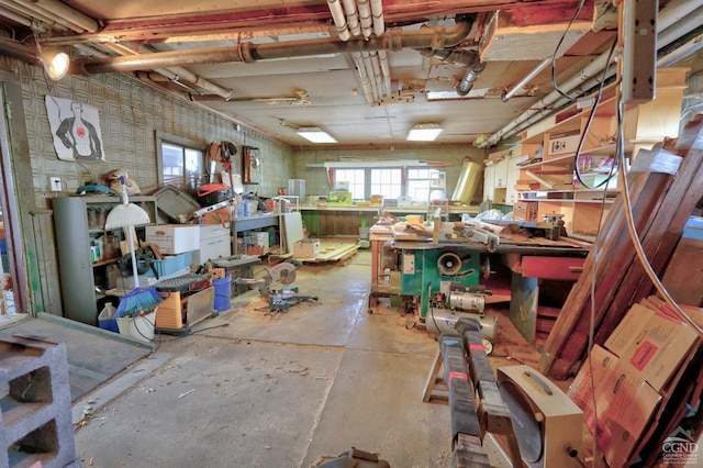 misc room with a workshop area and concrete flooring