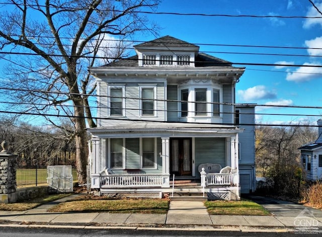 italianate home with covered porch and a balcony