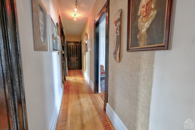 hallway with light hardwood / wood-style flooring