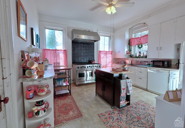 kitchen with tasteful backsplash, wall chimney exhaust hood, white appliances, white cabinets, and a center island