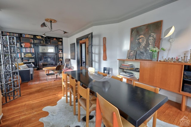 dining space featuring crown molding and wood-type flooring