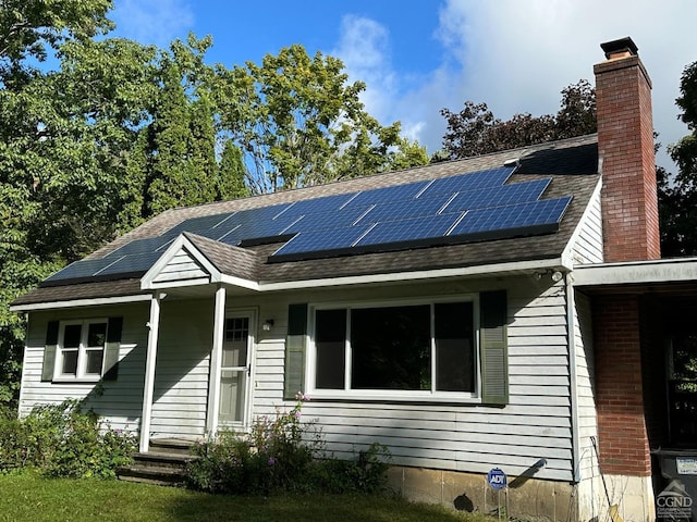 view of front of property featuring solar panels