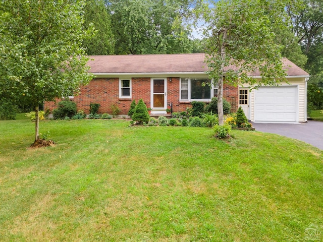 single story home featuring a garage and a front yard