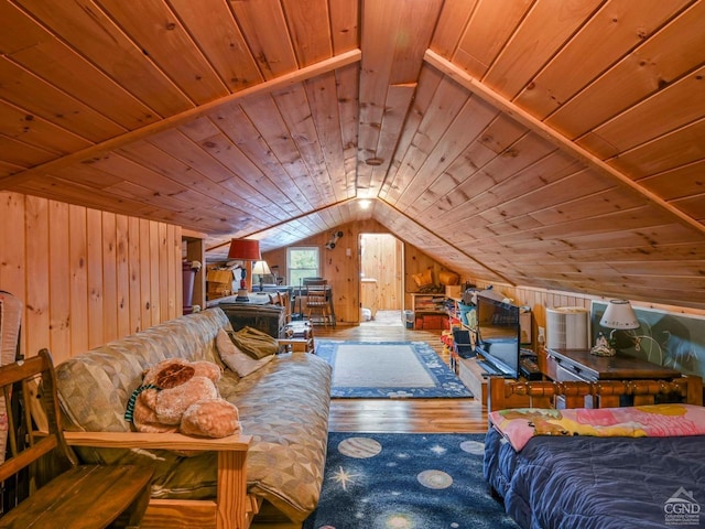 interior space featuring vaulted ceiling, wooden walls, wooden ceiling, and wood finished floors