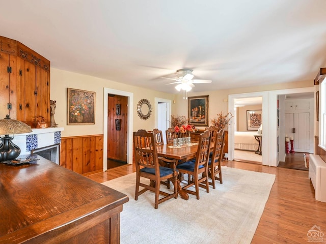 dining space with a ceiling fan and light wood-type flooring