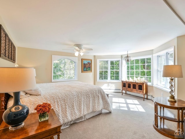 carpeted bedroom featuring baseboard heating, a baseboard heating unit, and a ceiling fan