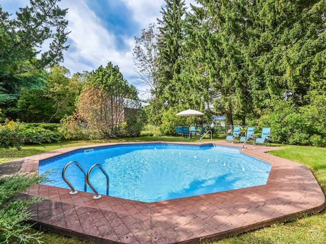 pool featuring a patio and fence