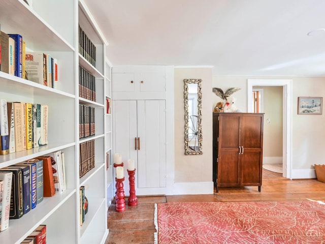 bedroom with light wood-type flooring and baseboards