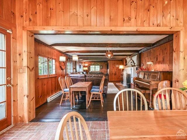 dining area with a baseboard radiator, beam ceiling, brick floor, an AC wall unit, and wood walls