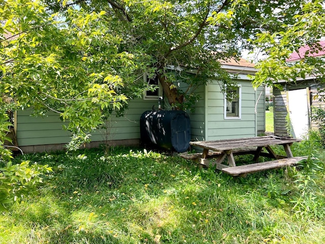 exterior space featuring heating fuel and a yard