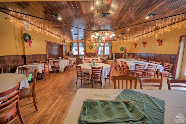 dining space featuring a chandelier, hardwood / wood-style floors, and wood ceiling