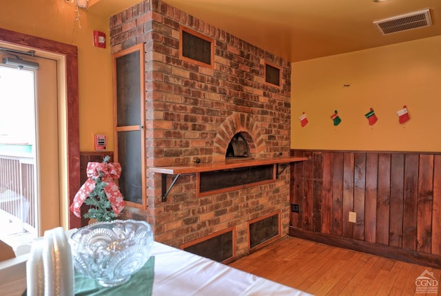 living room with wooden walls and hardwood / wood-style floors