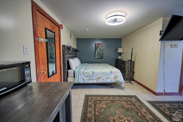 bedroom with light tile patterned floors