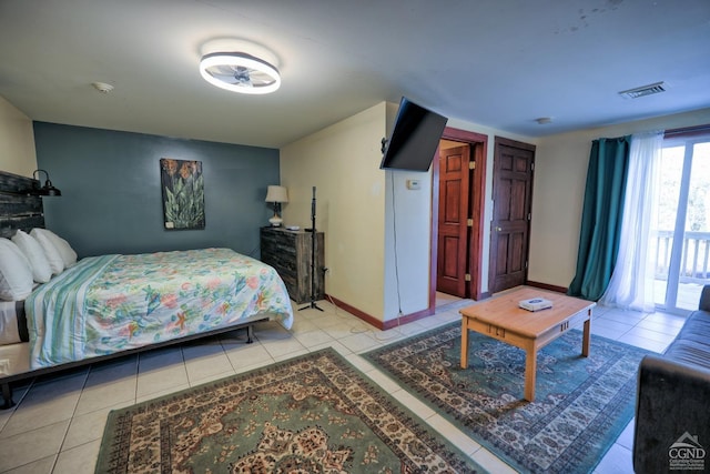 bedroom with light tile patterned floors and access to outside