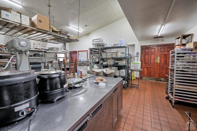 kitchen featuring tile patterned flooring and stainless steel counters