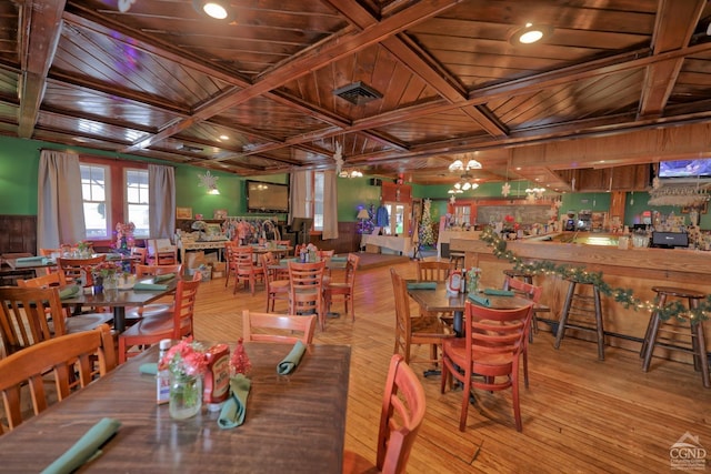 dining room featuring beamed ceiling, light hardwood / wood-style flooring, coffered ceiling, and wood ceiling