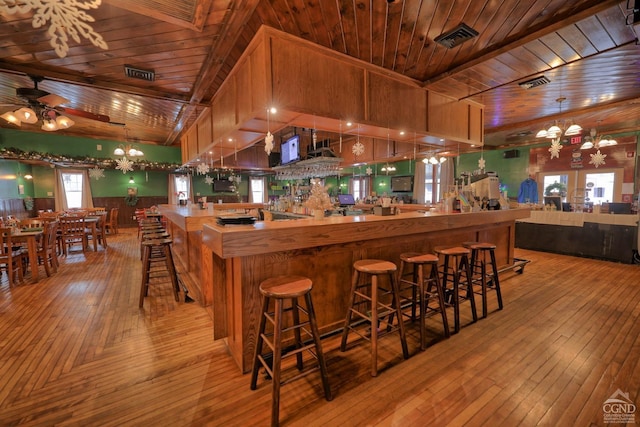 kitchen featuring ceiling fan with notable chandelier, decorative light fixtures, wooden ceiling, and light hardwood / wood-style floors