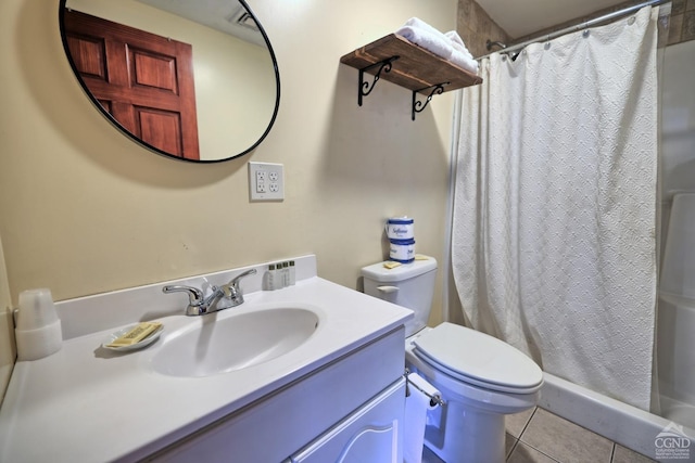 bathroom with tile patterned floors, curtained shower, vanity, and toilet