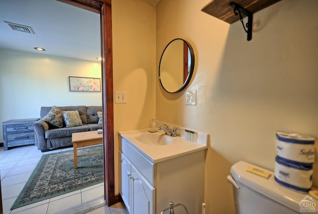 bathroom featuring tile patterned flooring, vanity, and toilet